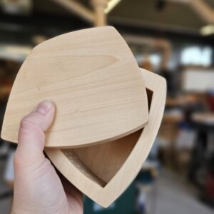 hand holding a bandsaw box with lid
