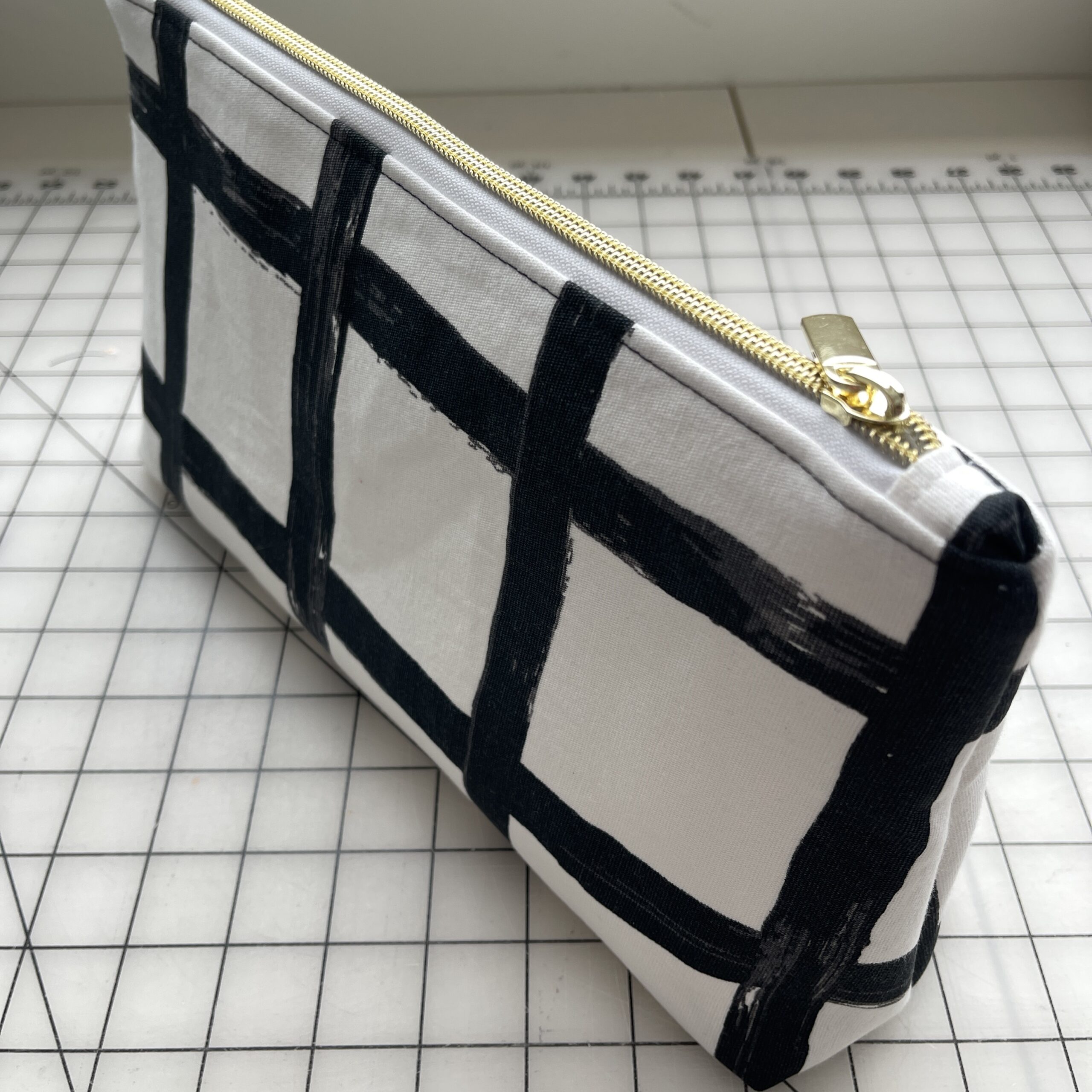 close up of a black and white fabric zipper pouch