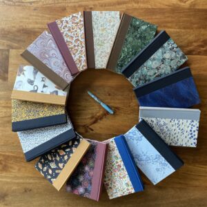 journal books laying in a circle on a wooden table