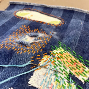 visible mending stitches on fabric and denim fabric
