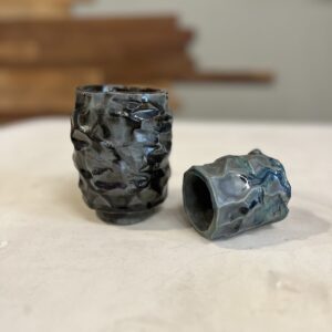 two small kurinuki clay tea cups on a table