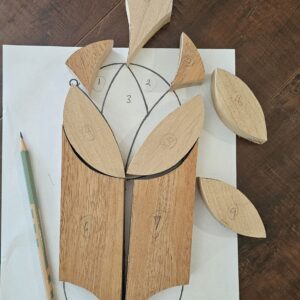 wooden intarsia pieces laying on paper pattern template
